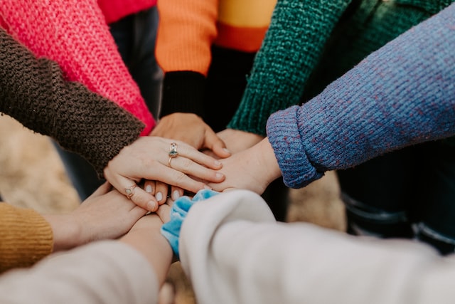 group of hands by Hannah Busing/Unsplash